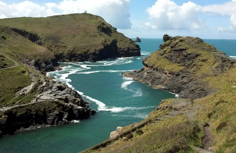 The harbour entrance at Boscastle between steep green headlands.